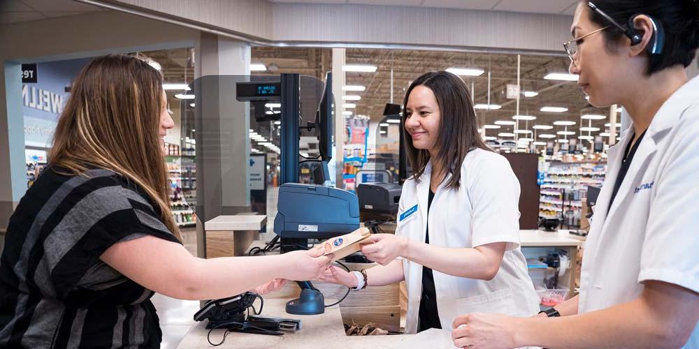 View all available scholarship at MU's Pharmacy Program. Photo displays a student working in a local pharmacy.